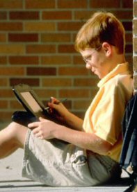 photo: boy with laptop computer